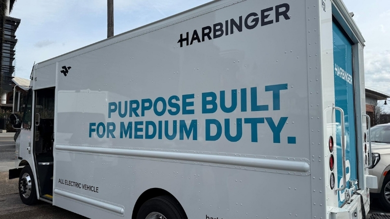 Harbinger all-electric medium-duty truck with side branding displayed outdoors